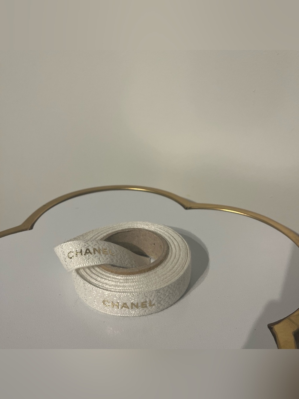 Authentic CHANEL wheel of White Ribbon with Gold Logo